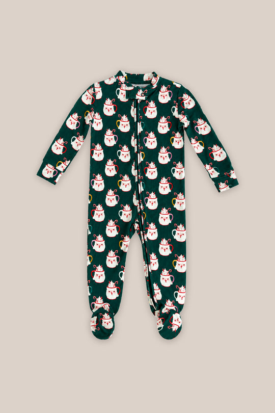 The Baby So Soft Onesie in Very Merry Santa by Ivy City Co features a dark green cotton-modal knit with white cat prints in red Santa hats, a front zipper, and long sleeves, shown on a beige background.
