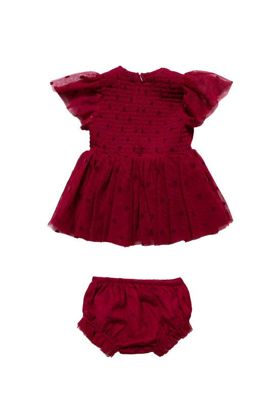 Red baby dress with matching bloomers on a white background