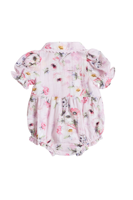 The Ivy City Co Baby Sophia Romper in Roselyn Pink has short puffed sleeves, a pink, purple, and yellow floral pattern, elastic leg openings, a small collar, and is shown from the back—ideal for mommy-and-me moments.