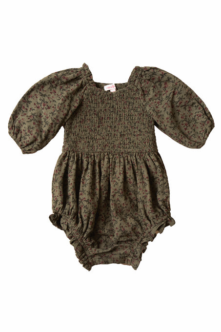 The Ivy City Co Baby Teagan Romper in Woodland Floral features a smocked bodice, elastic leg openings, and a charming floral design.