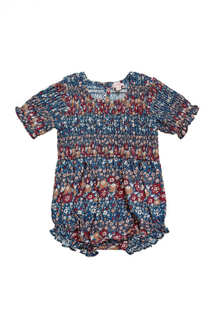 floral romper with a navy blue base, on a white background 