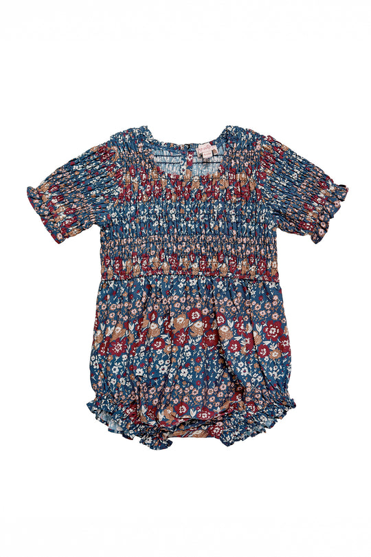 floral romper with a navy blue base, on a white background 