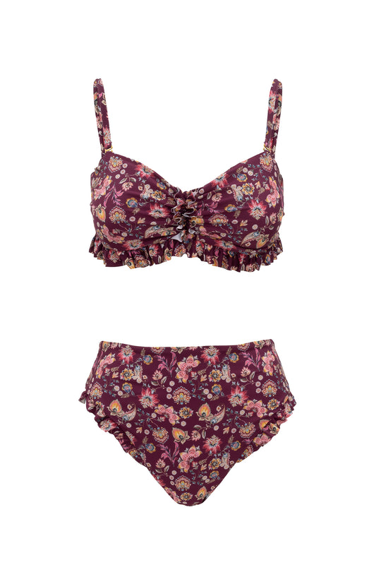 The Ivy City Co High Waist Ruffle Bottom in Stephanie Floral is a two-piece bikini featuring a burgundy base with pink, yellow, and green florals. The top has ruffles and adjustable straps; the high-waist bottoms include matching ruffled edges.