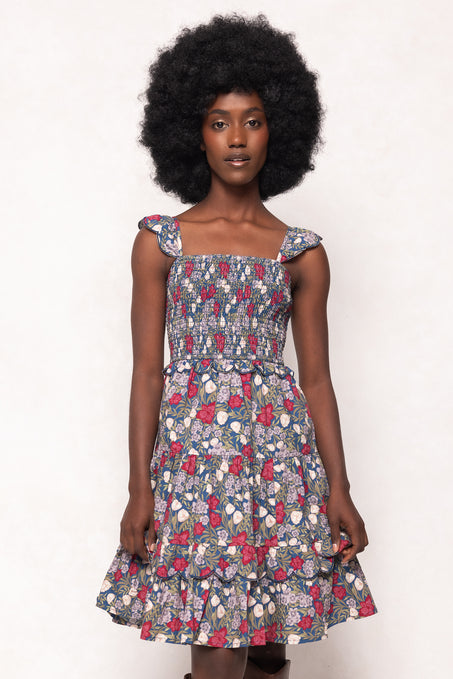 Woman wearing a floral dress against a white background