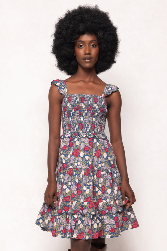 Woman wearing a floral dress against a white background