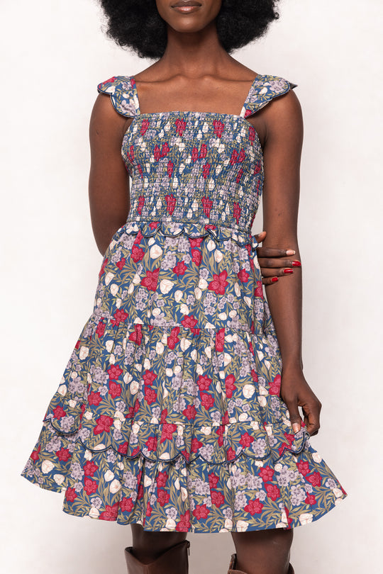Woman wearing a floral dress with a white background