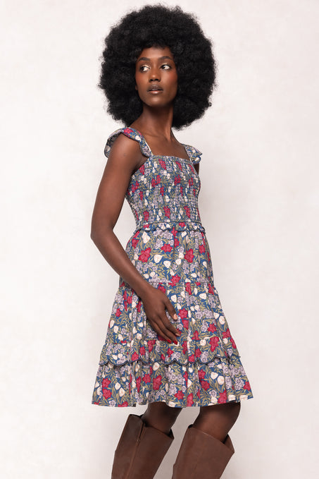 Woman wearing a floral dress with a white background