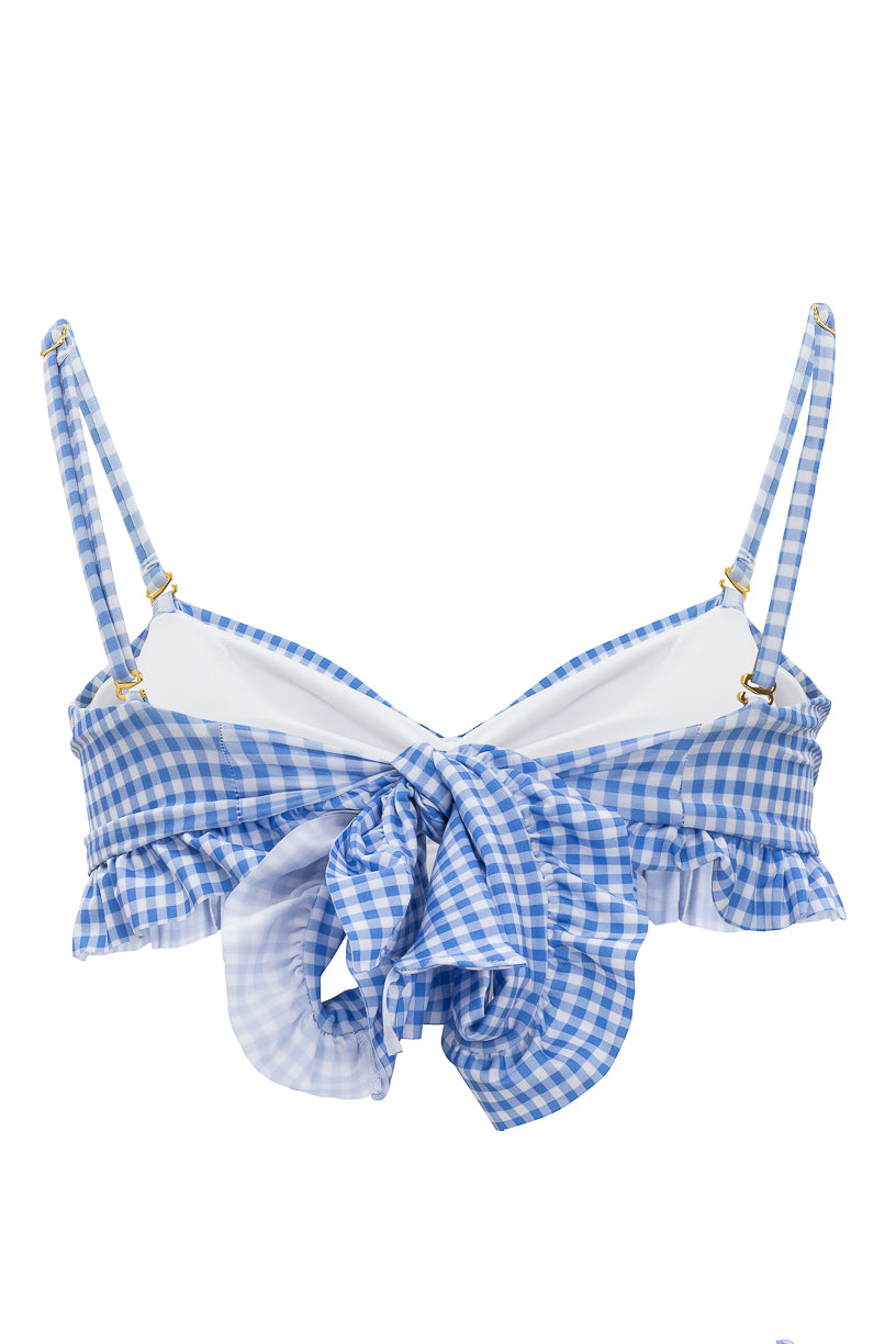 The Brandi Bandeau Top in Blakely Gingham by Ivy City Co features adjustable straps, ruffled trim, and a large front bow tie in blue and white gingham.