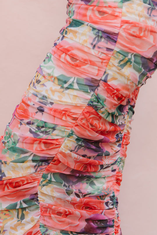 Close-up of the Ivy City Co Brynn Short Sleeve Dress in Multicolor Floral, featuring horizontal ruching and a vibrant floral print on a light background—designed to be chic and maternity-friendly.