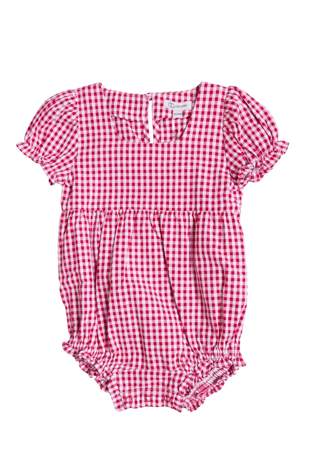 The Ivy City Co Baby Jessie Romper in Red Gingham features short puff sleeves, ruffled leg openings, and a buttoned back—making it a perfect festive choice for the Fourth of July or a charming everyday favorite.