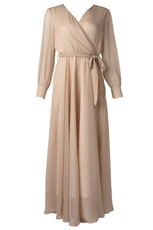The Andie Dress in Champagne by Ivy City Co is a long, light beige maternity maxi dress featuring long sleeves, a V-neckline, and a matching fabric belt tied at the waist. Its flowing, floor-length skirt is designed to provide stylish comfort throughout your pregnancy.