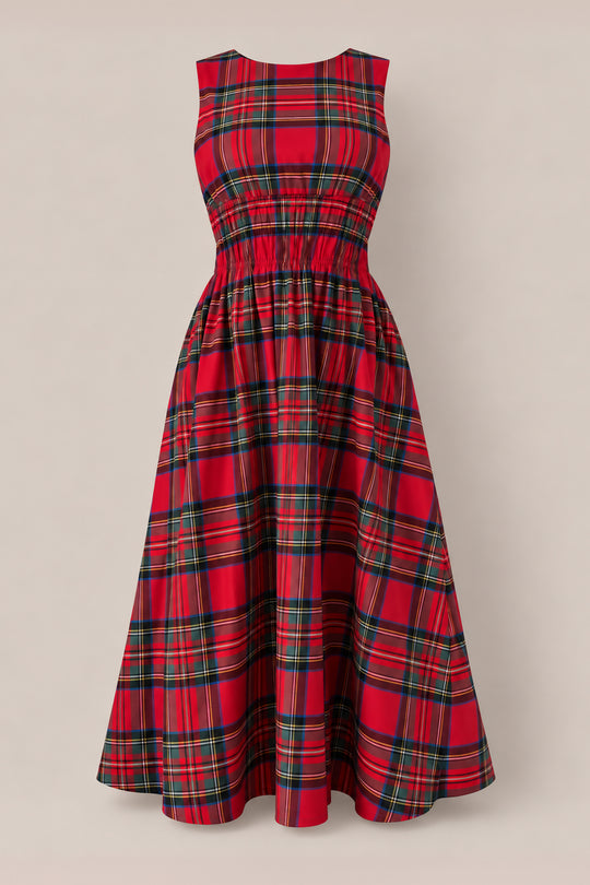 The Carly Dress in Holiday Plaid by Ivy City Co is a sleeveless, red plaid midi dress with a fitted, gathered waist and flared skirt—maternity friendly and perfect for Christmas—shown on a plain beige background.