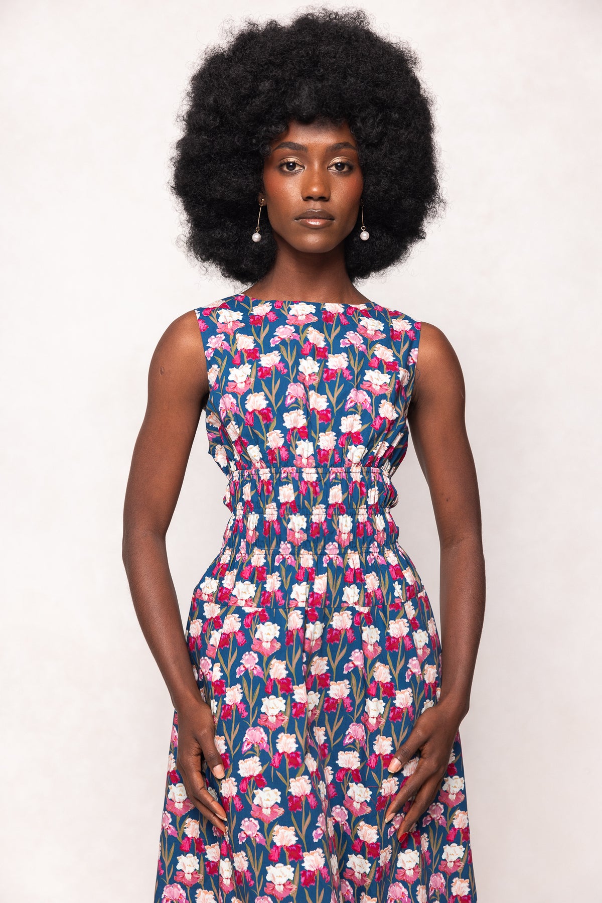 Woman wearing a floral dress against a white background