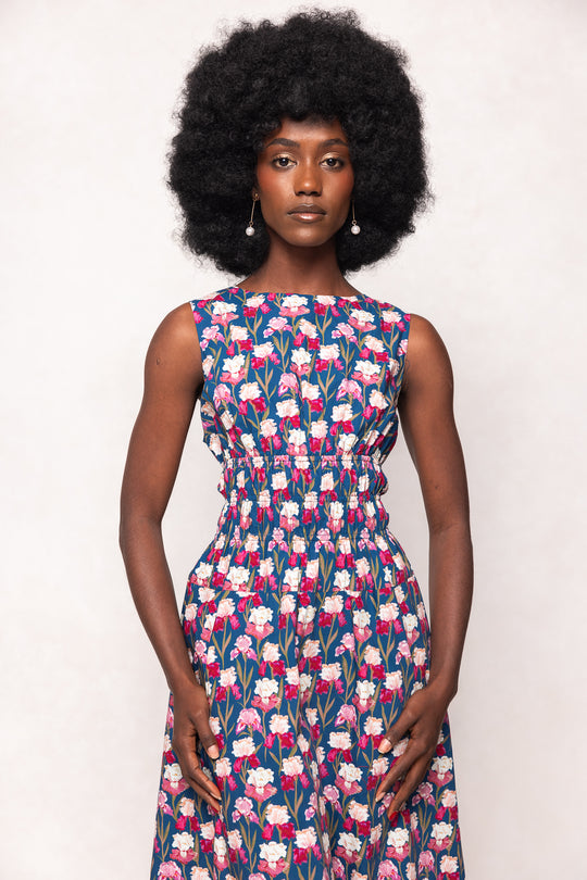 Woman wearing a floral dress against a white background