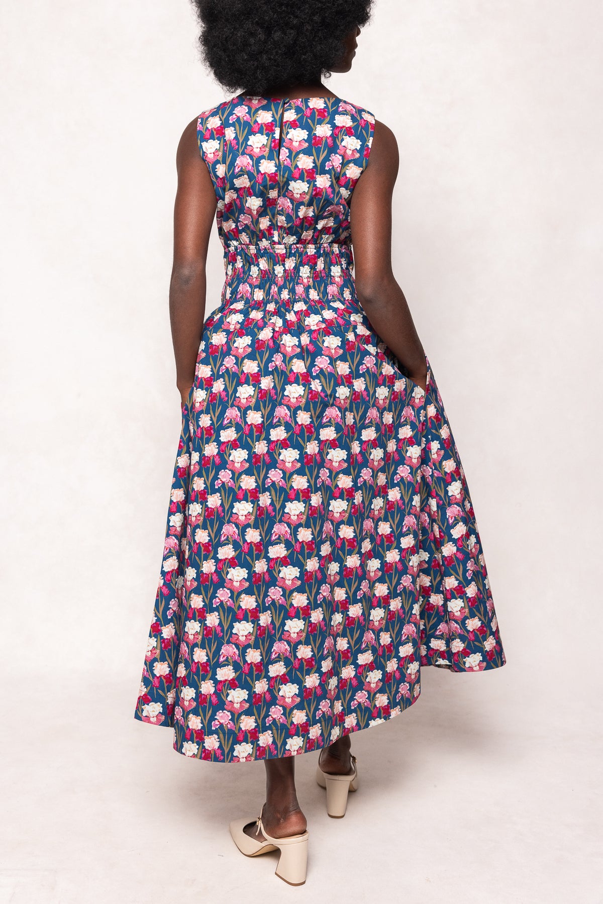 Woman wearing a floral dress with a white background