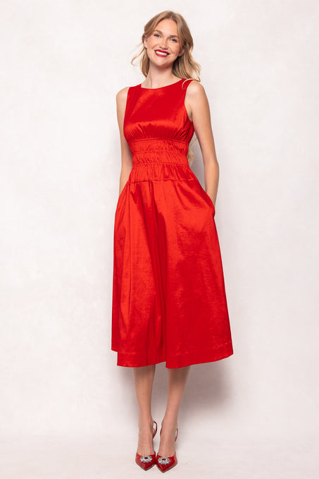 Woman wearing a red dress against a white background