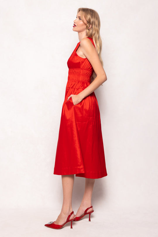 Woman wearing a red dress against a white background