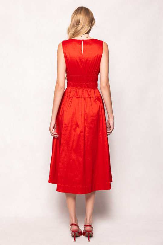 Woman wearing a red dress against a white background