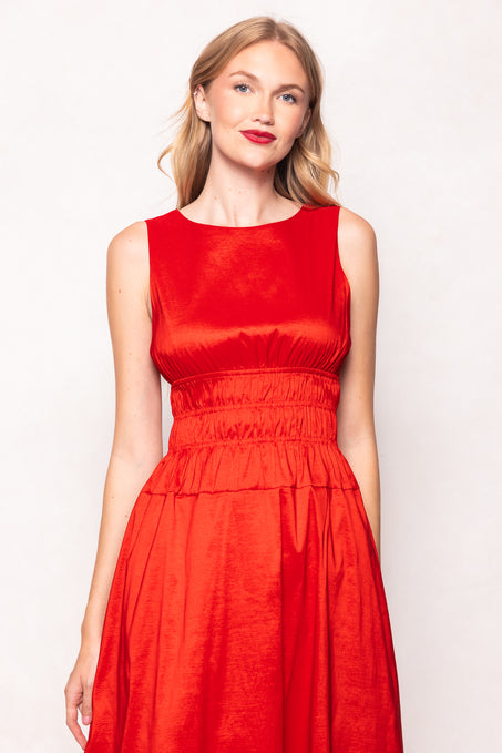 Woman wearing a red dress against a white background