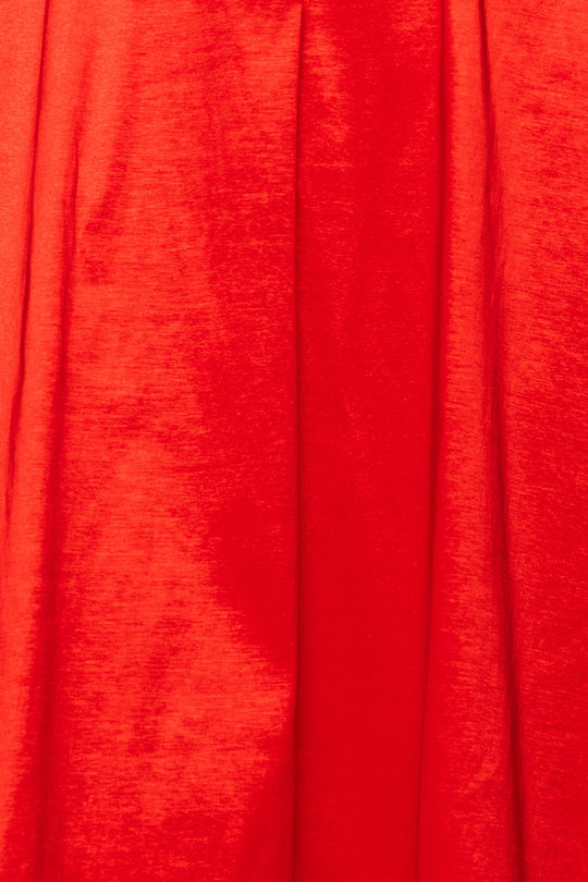 Detailed close-up of the Carly Dress in Red Taffeta by Ivy City Co showcases its rich red fabric with a subtle texture and soft folds that form elegant vertical lines—ideal for a festive holiday look or any occasion requiring sophisticated style.