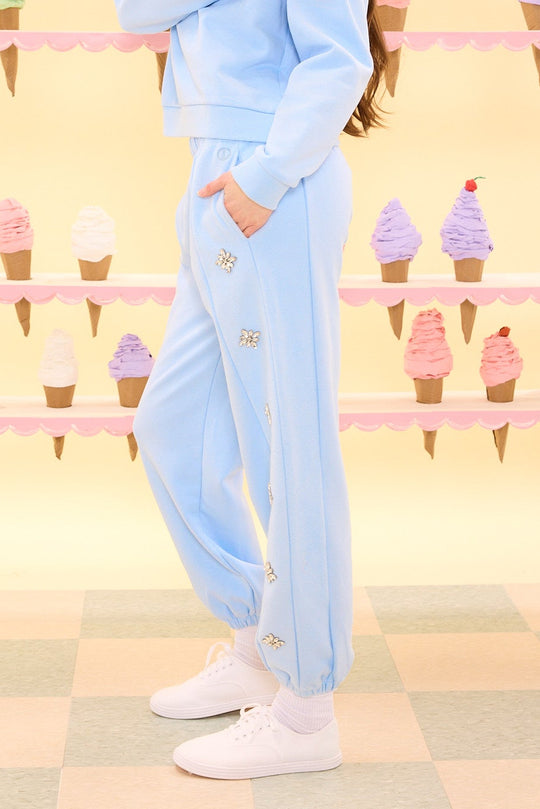 Person wearing a light blue tracksuit with ice cream cone background