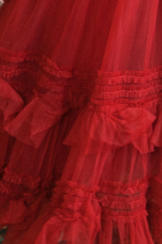 Close-up of layers of bright red garnet tulle fabric with ruffled, gathered details on the Celestine Skirt in Garnet by Ivy City Co. The image highlights the texture and layered design of this festive girls’ skirt.