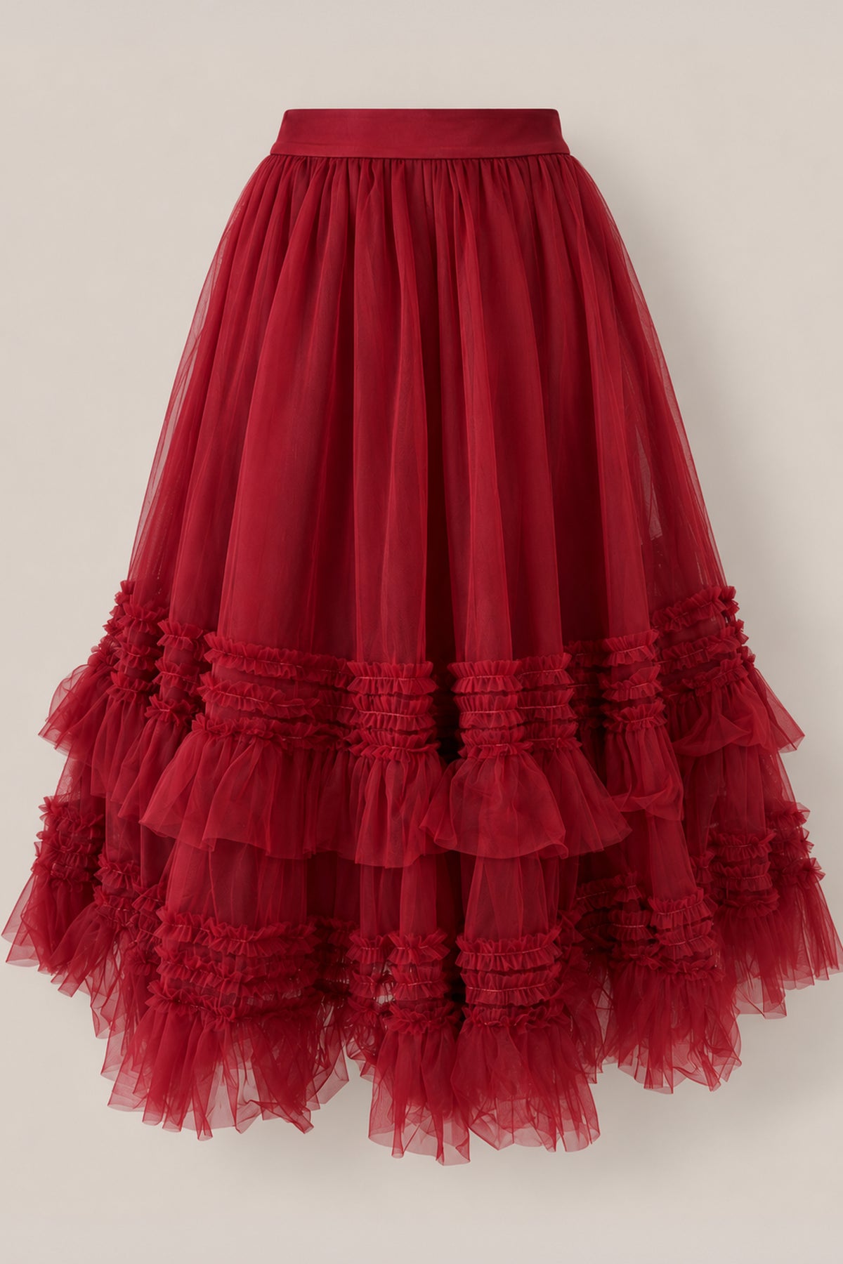 The Celestine Skirt in Garnet by Ivy City Co features a fitted waistband and multiple layers of ruffled, gathered tulle arranged in horizontal rows near the hem, creating a voluminous and textured look—making it the perfect festive skirt for girls this holiday season.