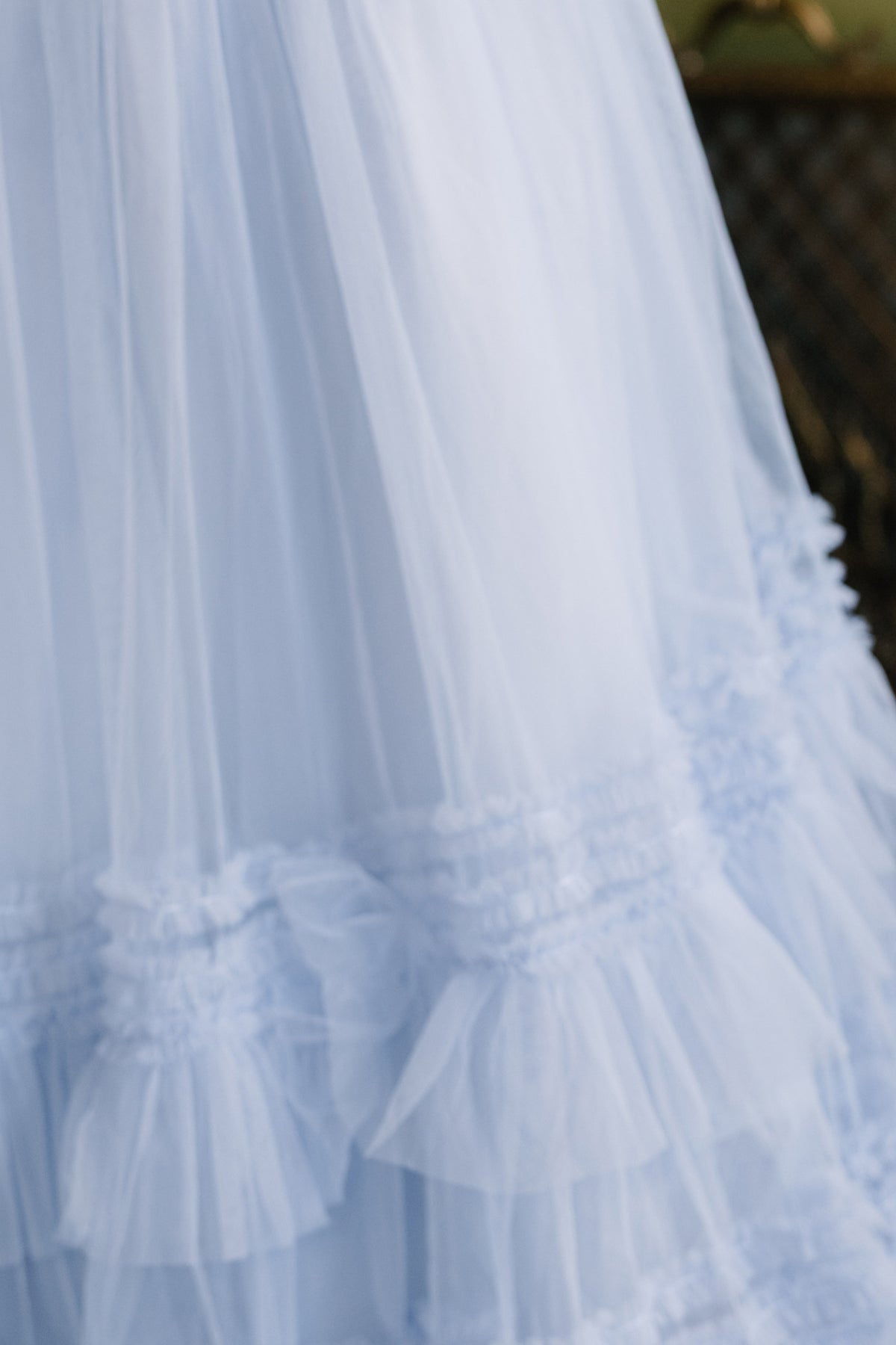 A close-up of the Ivy City Co Celestine Skirt in Misty Blue highlights its ruffled, layered, and gathered tulle details and soft, sheer texture—making it a charming choice for a holiday recital outfit.