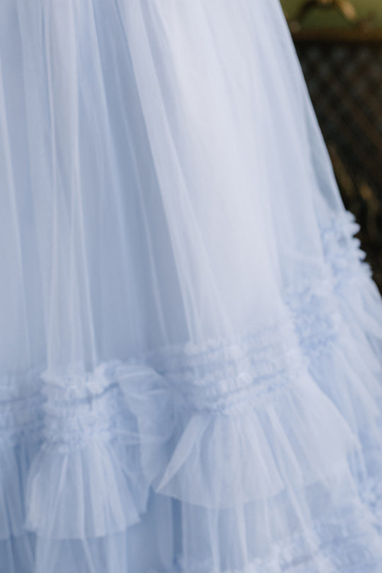 A close-up of the Ivy City Co Celestine Skirt in Misty Blue highlights its ruffled, layered, and gathered tulle details and soft, sheer texture—making it a charming choice for a holiday recital outfit.