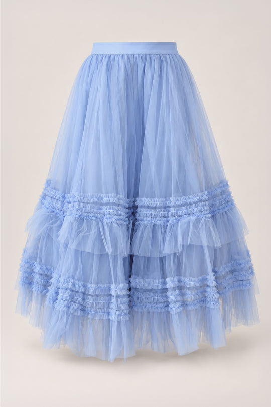 The Celestine Skirt in Misty Blue by Ivy City Co features voluminous layers of misty blue tulle with cascading ruffled tiers and a fitted waistband, displayed on a simple light background—an enchanting girls’ skirt that’s perfect for a holiday recital outfit.