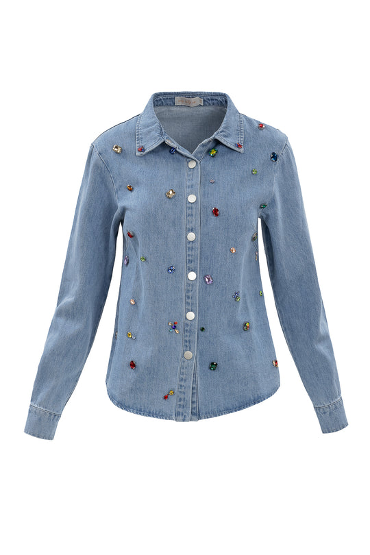 The Ivy City Co Rhinestone Cowboy Shirt features light blue denim, long sleeves, and colorful rhinestone embellishments adorning the front.