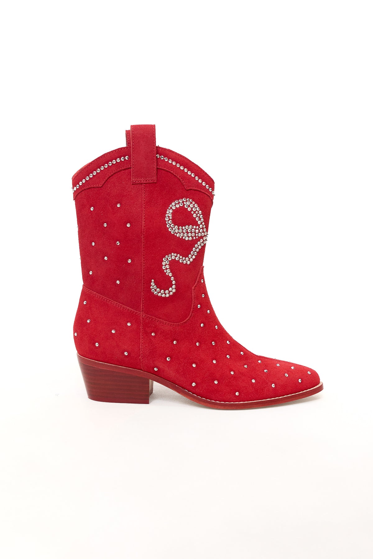 The Ivy City Co Channing Bootie in Red features bright suede with a low heel, adorned with silver studs and rhinestone swirls along the top. This standout western bootie is shown against a plain white background.