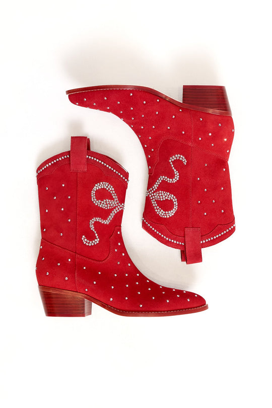 The Channing Bootie in Red by Ivy City Co features low wooden heels, silver stud accents, and rhinestone swirl designs for authentic western sparkle. Shown on a white background, one red suede bootie is laid flat while the other is slightly angled.