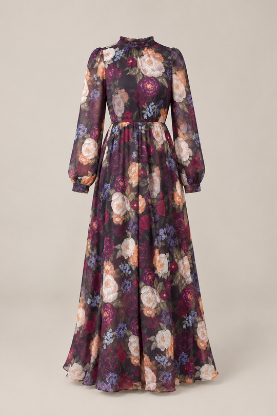 The Kelley Dress in Winter Floral by Ivy City Co features long sleeves, a floor-length sheer fabric, high ruffled collar, fitted waist, and vibrant purple, red, white, and pink roses on a dark background—perfect for holiday portraits.