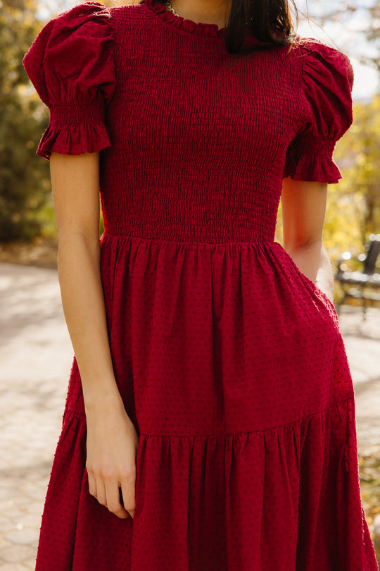 Close up of woman in red dress outside