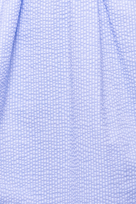 Close-up of Ivy City Cos Countryside Dress in Blue Seersucker, featuring light blue puckered fabric with a subtle checkered texture—ideal for nursing and maternity-friendly wear.