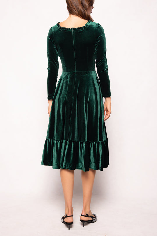 Green velvet dress with long sleeves on a white background