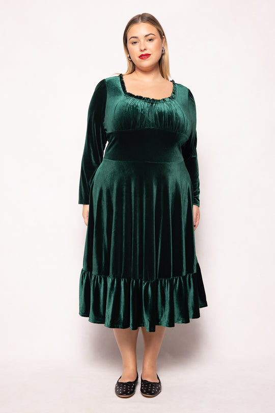 Woman wearing a green dress against a white background