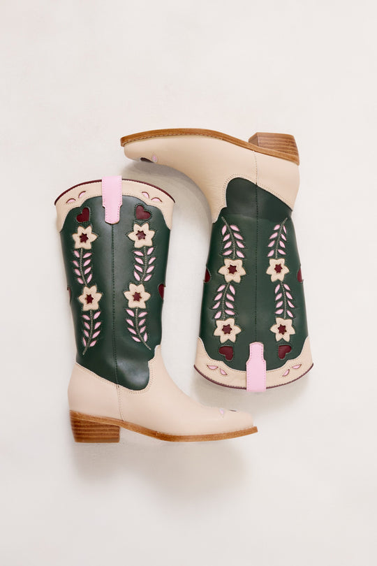 Pair of green cowboy boots with floral patterns on a white background