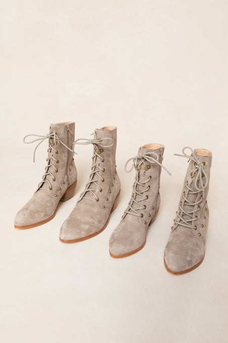 Two pairs of Ivy City Co Darcy Lace Up Studded Boots in light taupe suede with low wooden heels are arranged side by side on a neutral background.