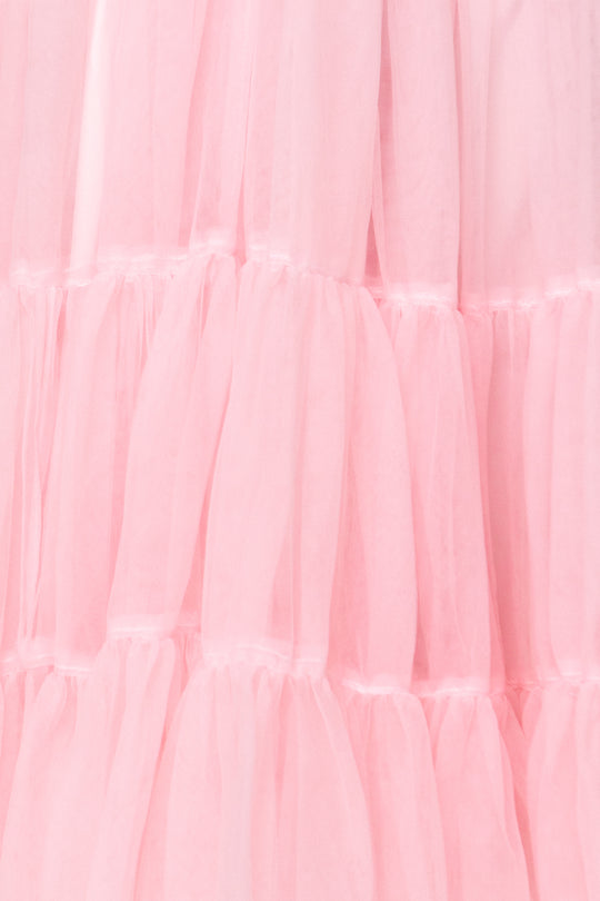 Close-up of soft, sheer pink tulle ruffles from the Destiny Dress in Pink by Ivy City Co, creating a delicate and airy texture—ideal for an elegant maternity or special occasion dress.