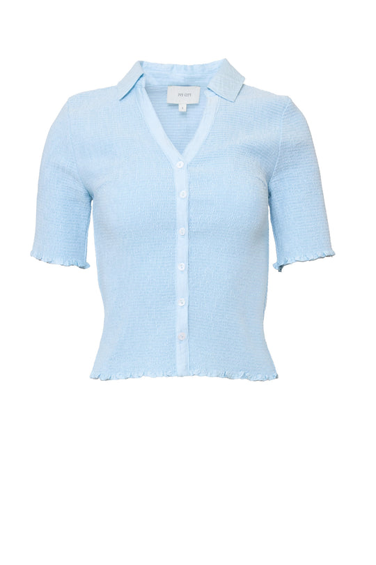 blue shirt in front a white background