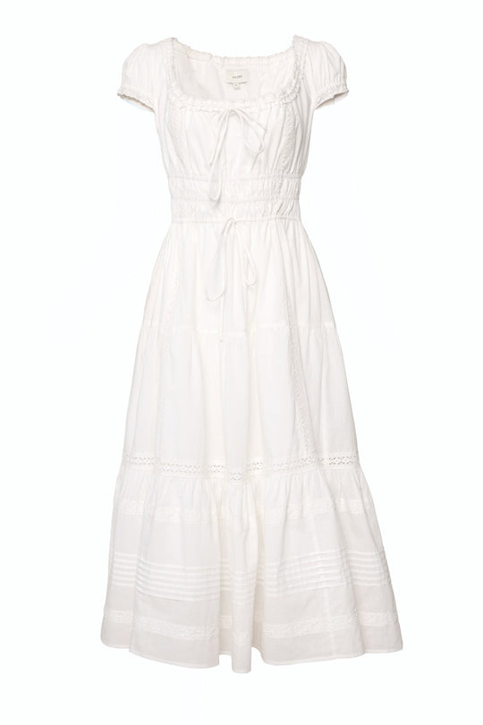 The Palermo Dress in White by Ivy City Co is a white, ankle-length dress with short sleeves, a square neckline, fitted waist, gathered bodice, and a tiered skirt accented by delicate lace and pleated details—this flowy style is both nursing-friendly and effortlessly elegant.