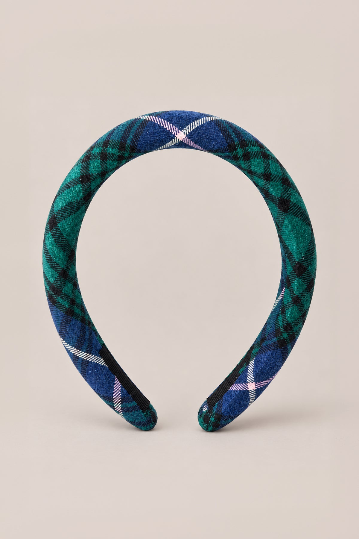 A charming holiday hair accessory, the Ivy City Co Hair Bows in Emerald Plaid features a wide, padded headband covered in rich green and blue tones with crisp white accents, beautifully displayed upright on a plain beige background.