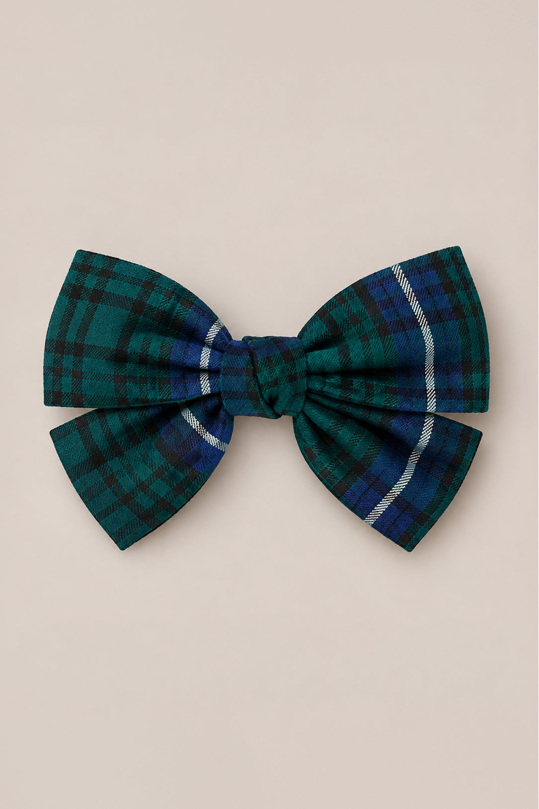 The Hair Bows in Emerald Plaid by Ivy City Co feature a center knot and a subtle white stripe on one side, set against a light beige background—making them a festive holiday hair accessory ideal for the Christmas season.