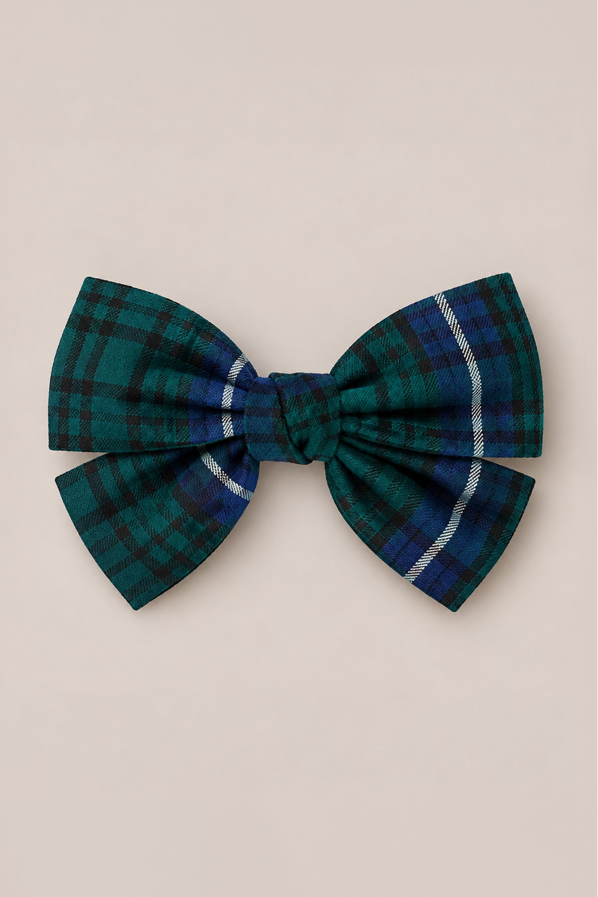 The Hair Bows in Emerald Plaid by Ivy City Co feature a center knot and a subtle white stripe on one side, set against a light beige background—making them a festive holiday hair accessory ideal for the Christmas season.