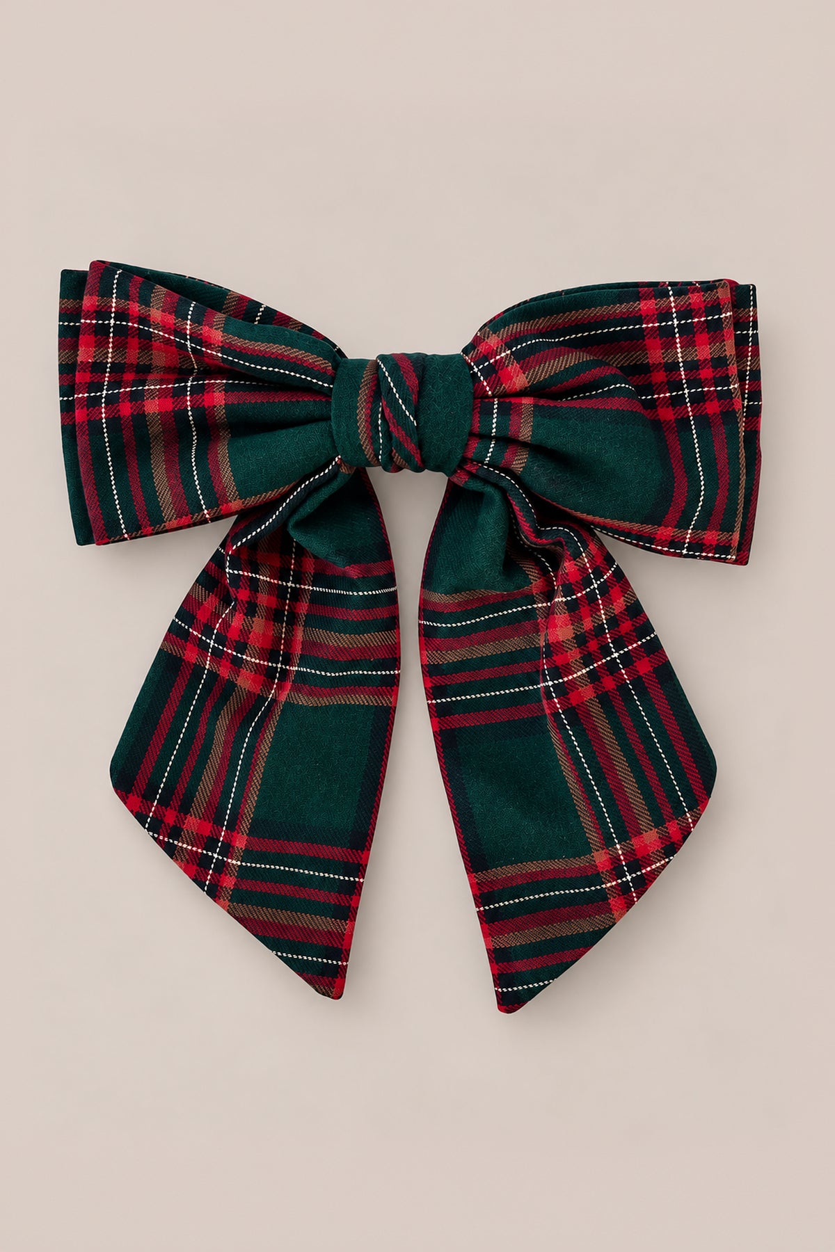 The Ivy City Co Hair Bows in Evergreen Plaid feature a large, neatly tied bow made from soft cotton flannel in a classic red, green, and white evergreen plaid pattern, displayed against a plain beige background.