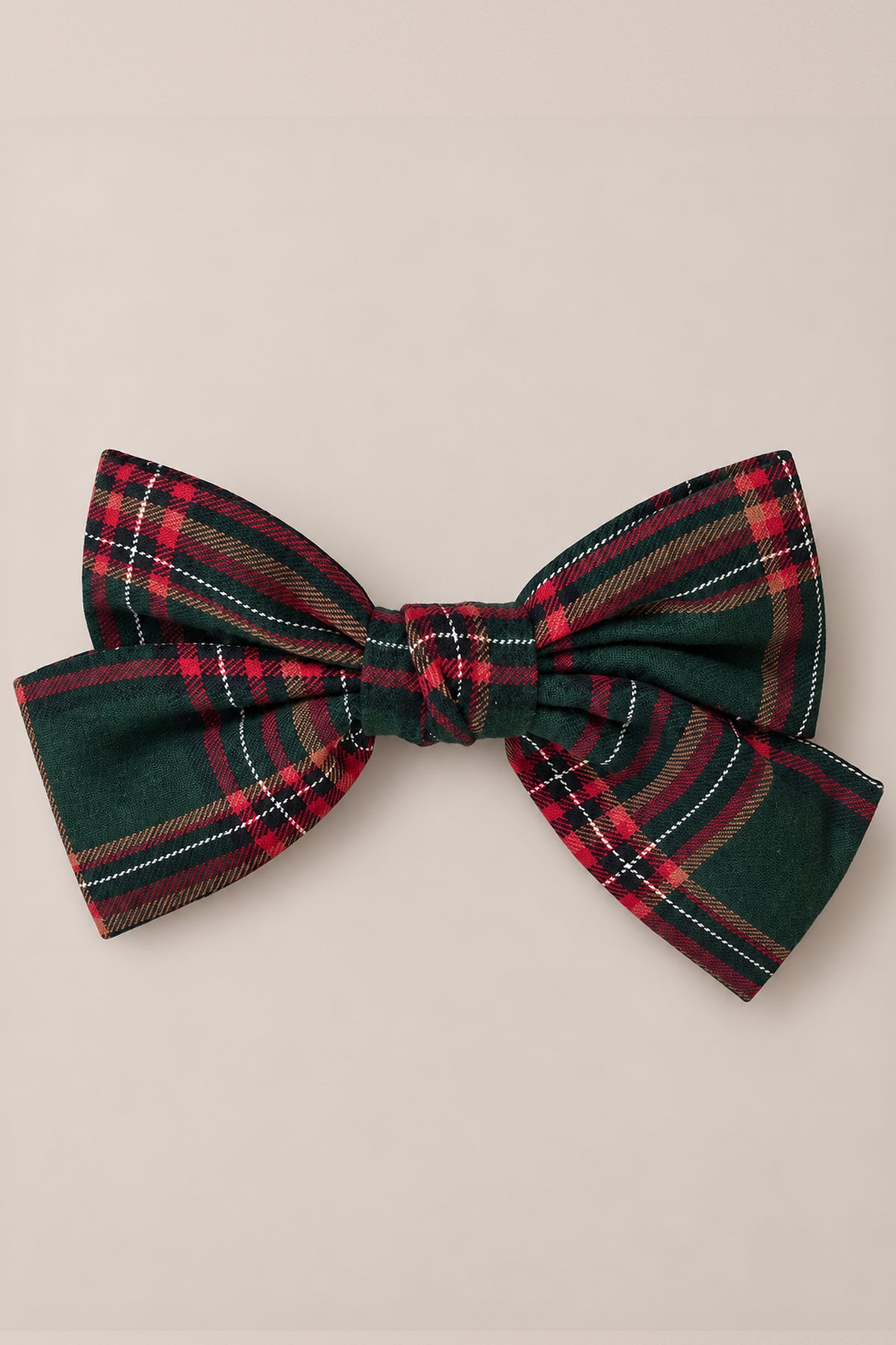The Ivy City Co Hair Bows in Evergreen Plaid showcase a large bow with green, red, and white stripes, crafted from soft cotton flannel and displayed against a plain light background.