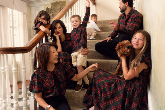 a family of adults and children sit on stairs