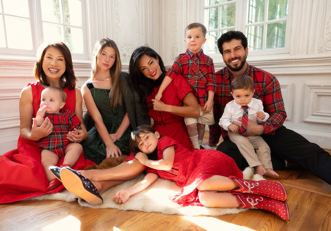 a family sits on the floor in front of a window
